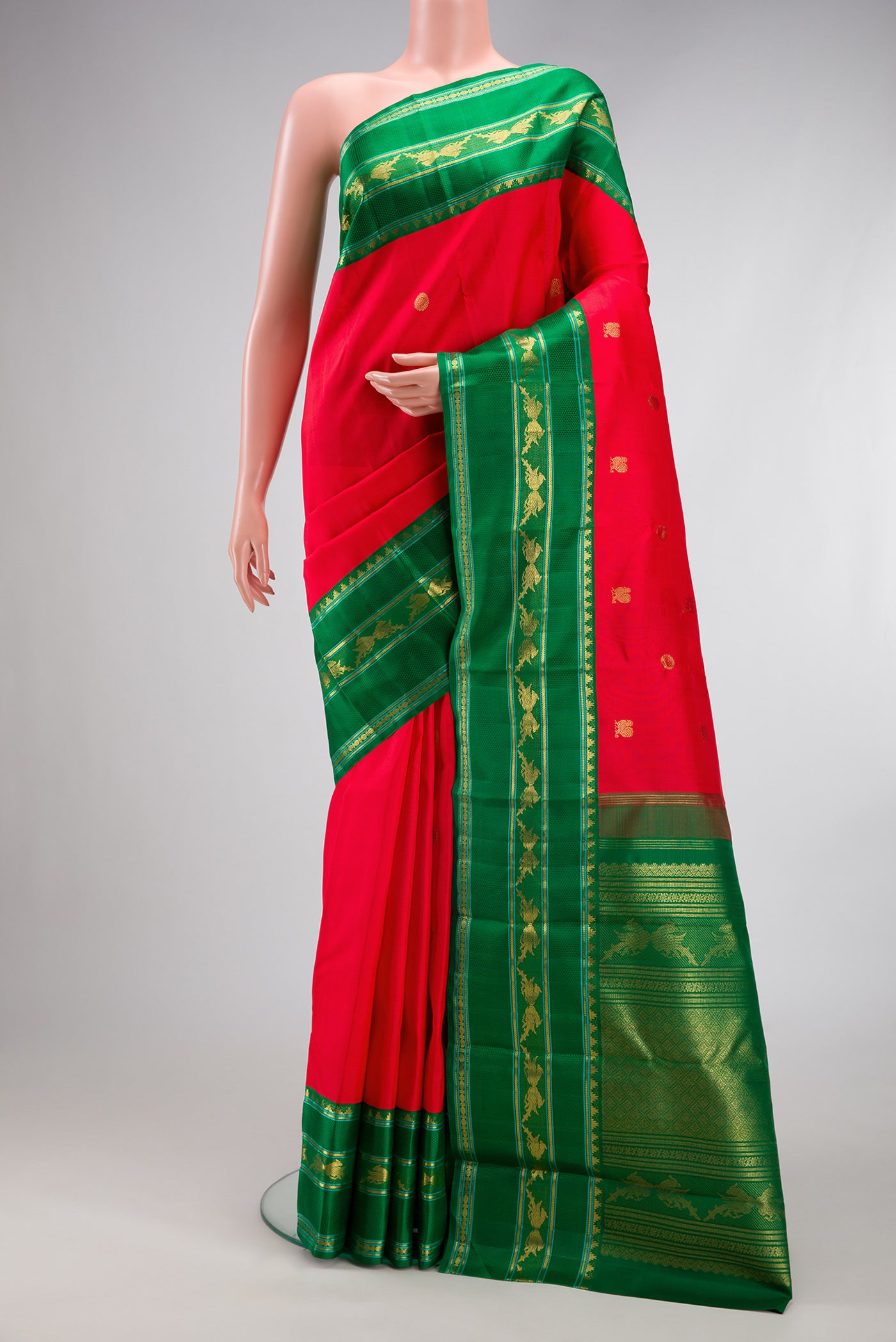 Pure Silk Pure Zari Red Kanjivaram Saree with Zari Butta on the body and Zari Border.  displayed on a mannequin