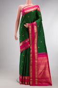 Pure Silk Pure Zari Green Kanjivaram Saree with Zari Butta on the body and Zari Border.  displayed on a mannequin