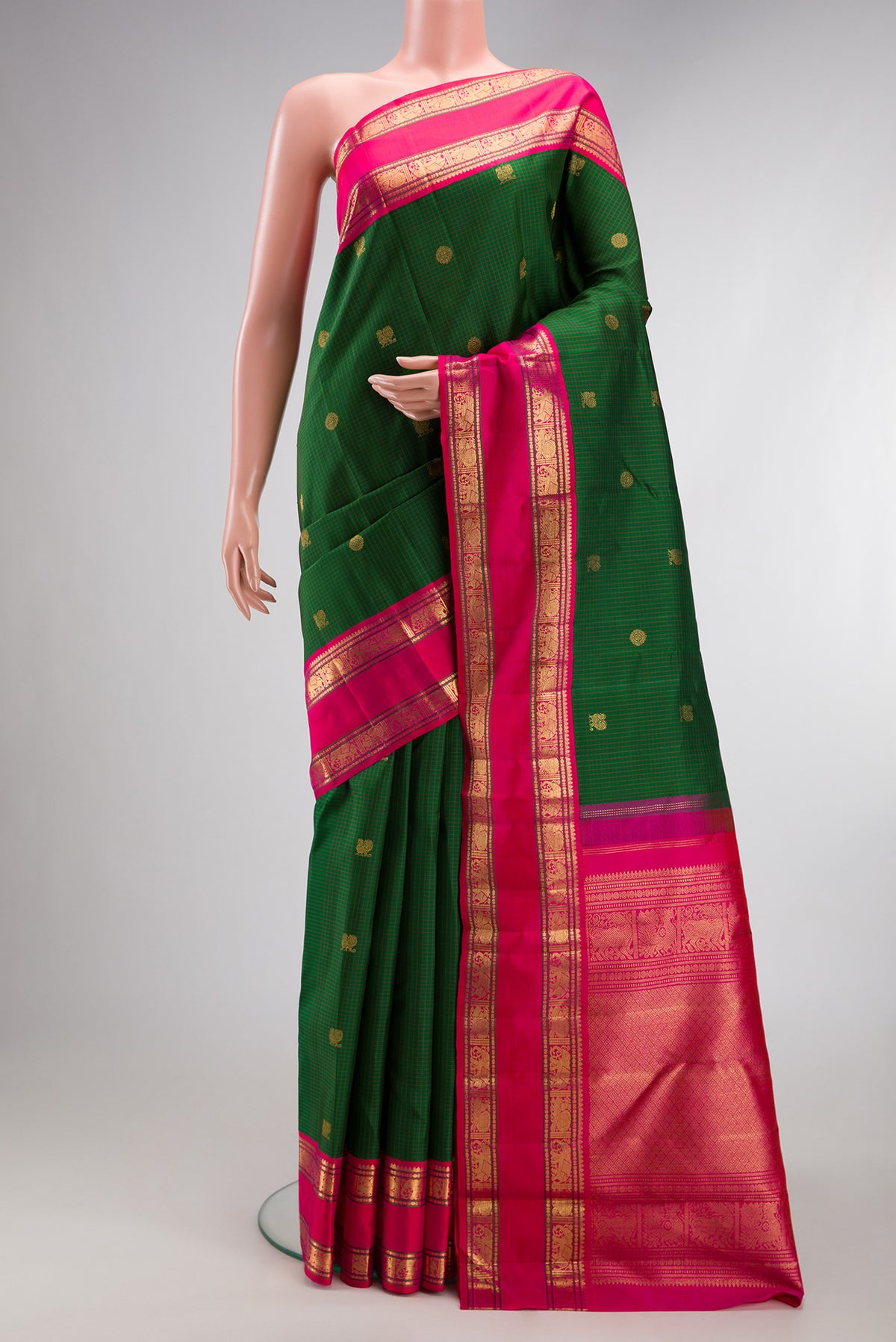Pure Silk Pure Zari Green Kanjivaram Saree with Zari Butta on the body and Zari Border.  displayed on a mannequin