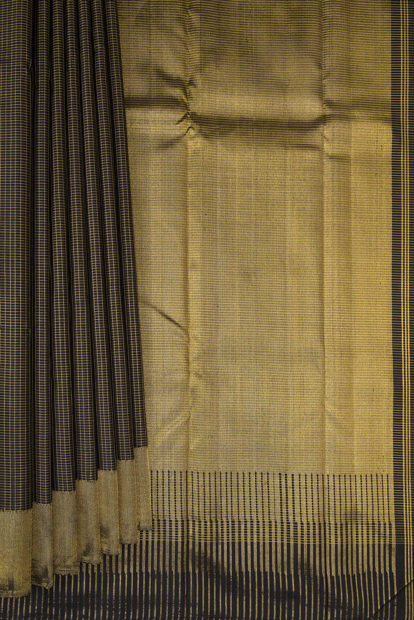 Pleats and pallu of Black Kanchipuram Silk Saree with Checked design on the body and Zari Border. 
