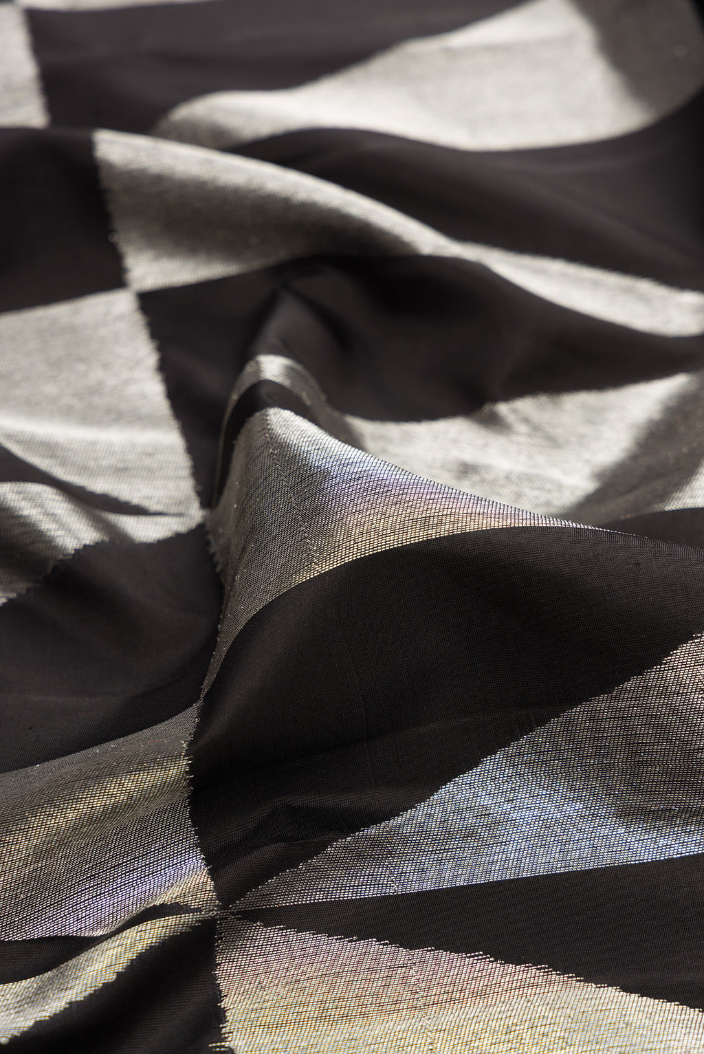 Close up of Pure Silk Black Dual Tone Kanchipuram Saree with Zari Brocade on the body and Without Border.  displaying folds