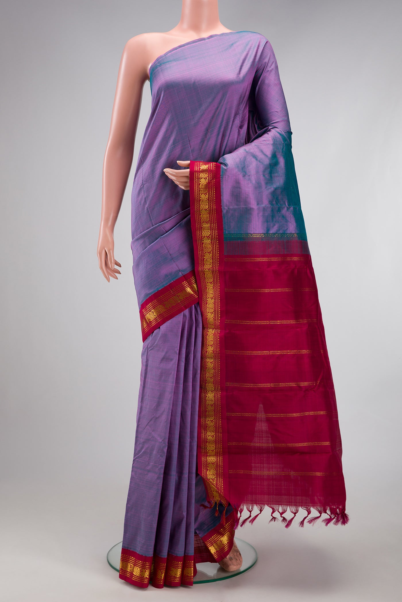 Pure Silk Pure Zari Purple Dual Tone Kanjivaram Saree with Plain Body and One Side Border.  displayed on a mannequin