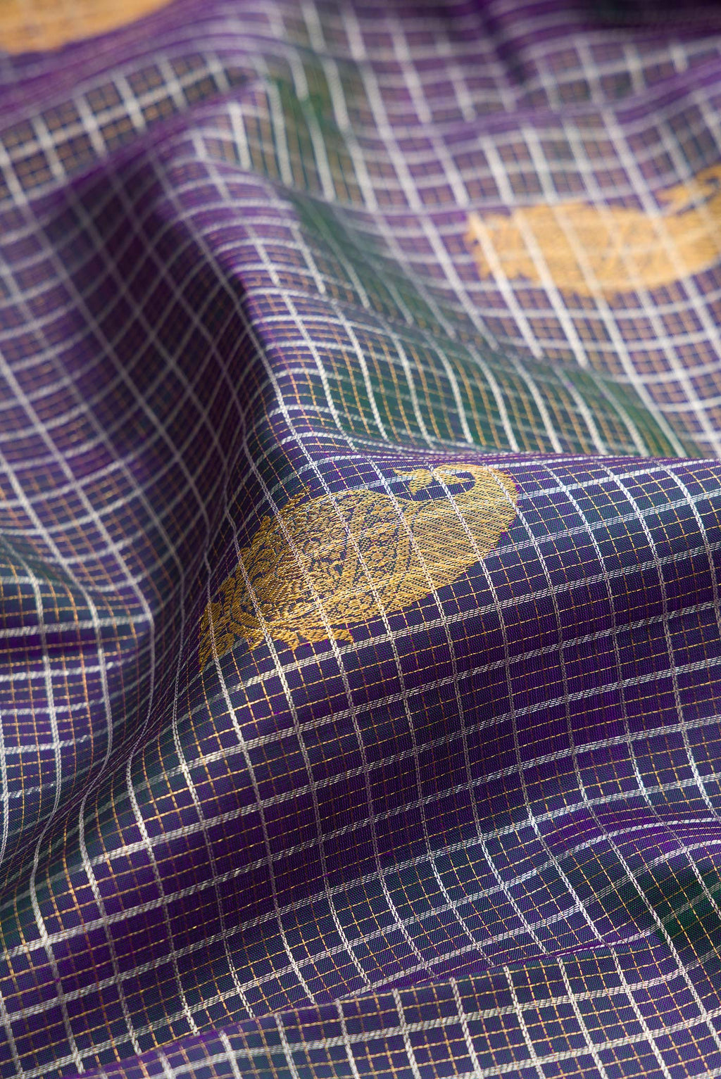 Close up of Peacock Blue Dual Tone Kanchipuram Silk Saree with Checked design on the body and Zari Border.  displaying folds