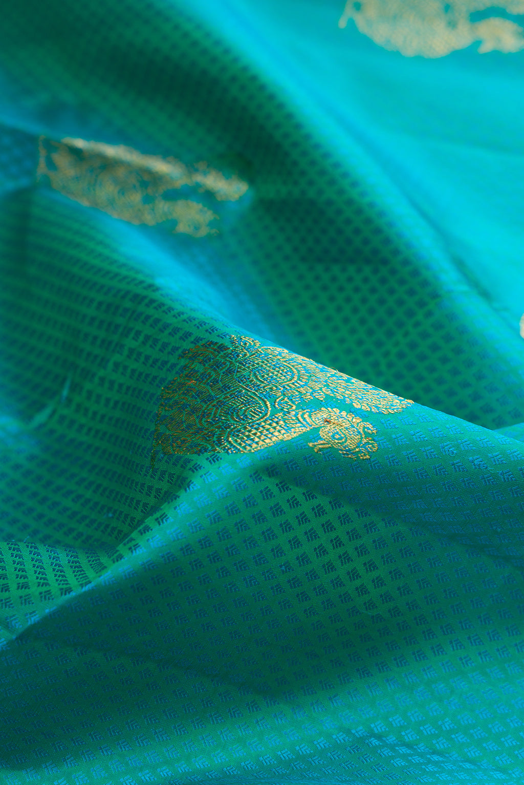 Close up of Sea Green Kanjivaram Silk Saree with Jacquard With Zari Butta on the body and Zari Border.  displaying folds