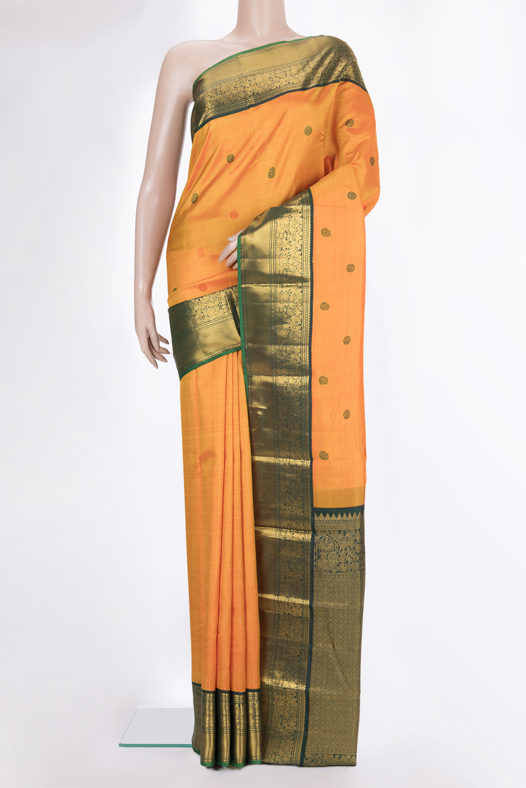 Pure Silk Orange Kanjivaram Saree with Thread Butta on the body and Zari Border.  displayed on a mannequin