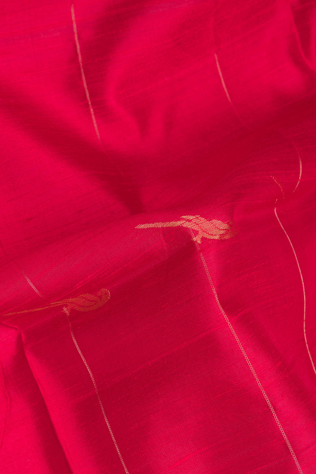 Close up of Pure Silk Red Dual Tone Raw Saree with Zari Butta on the body and Zari Border.  displaying folds