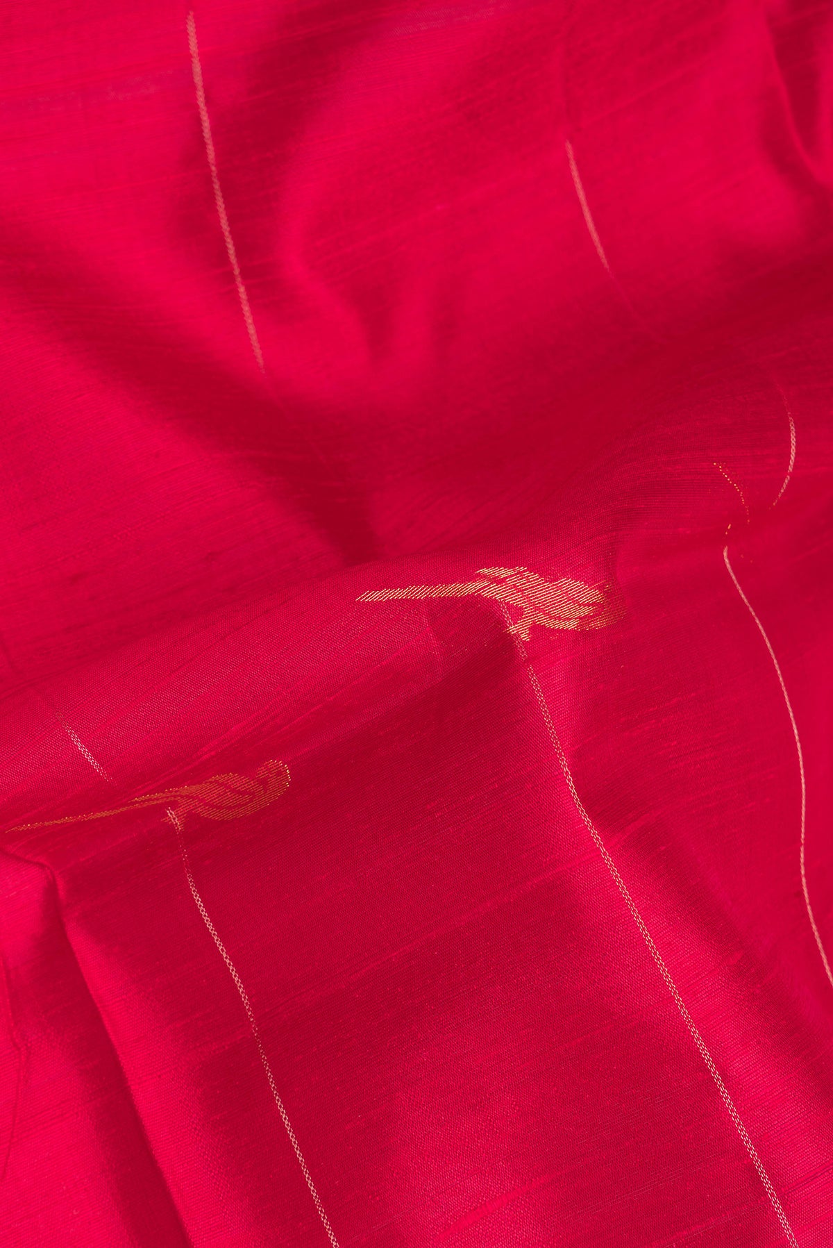 Close up of Pure Silk Red Dual Tone Raw Saree with Zari Butta on the body and Zari Border.  displaying folds