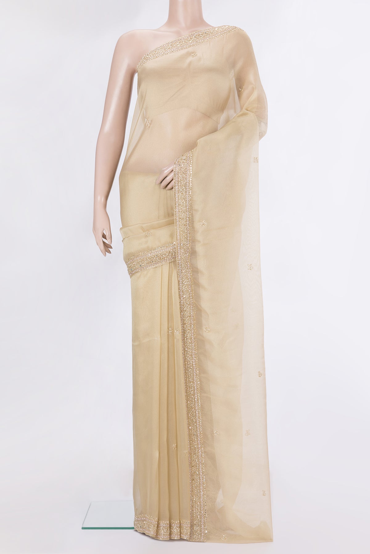 Beige Dual Tone Organza Saree with Embroidery on the body and Embroidery Border.  displayed on a mannequin