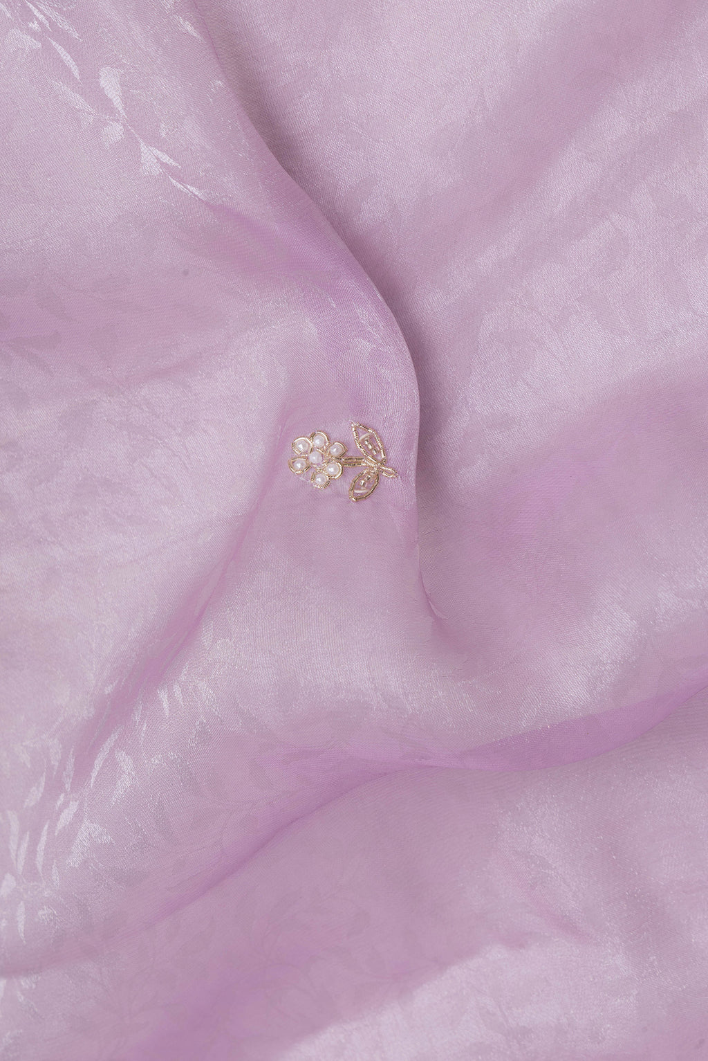 Close up of Lavender Organza Silk Saree with Embroidery on the body and Sequin Border.  displaying folds