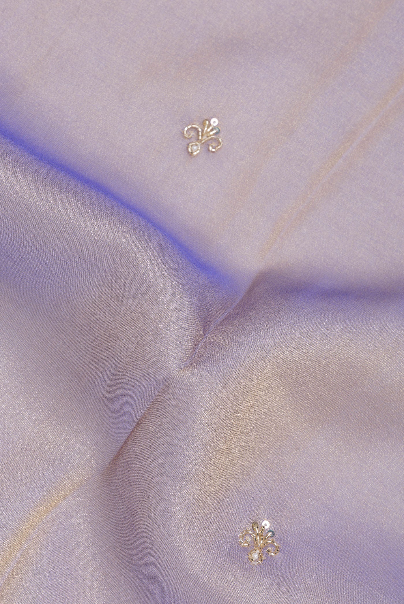 Close up of Purple Organza Silk Saree with Embroidery on the body and Sequin Border.  displaying folds