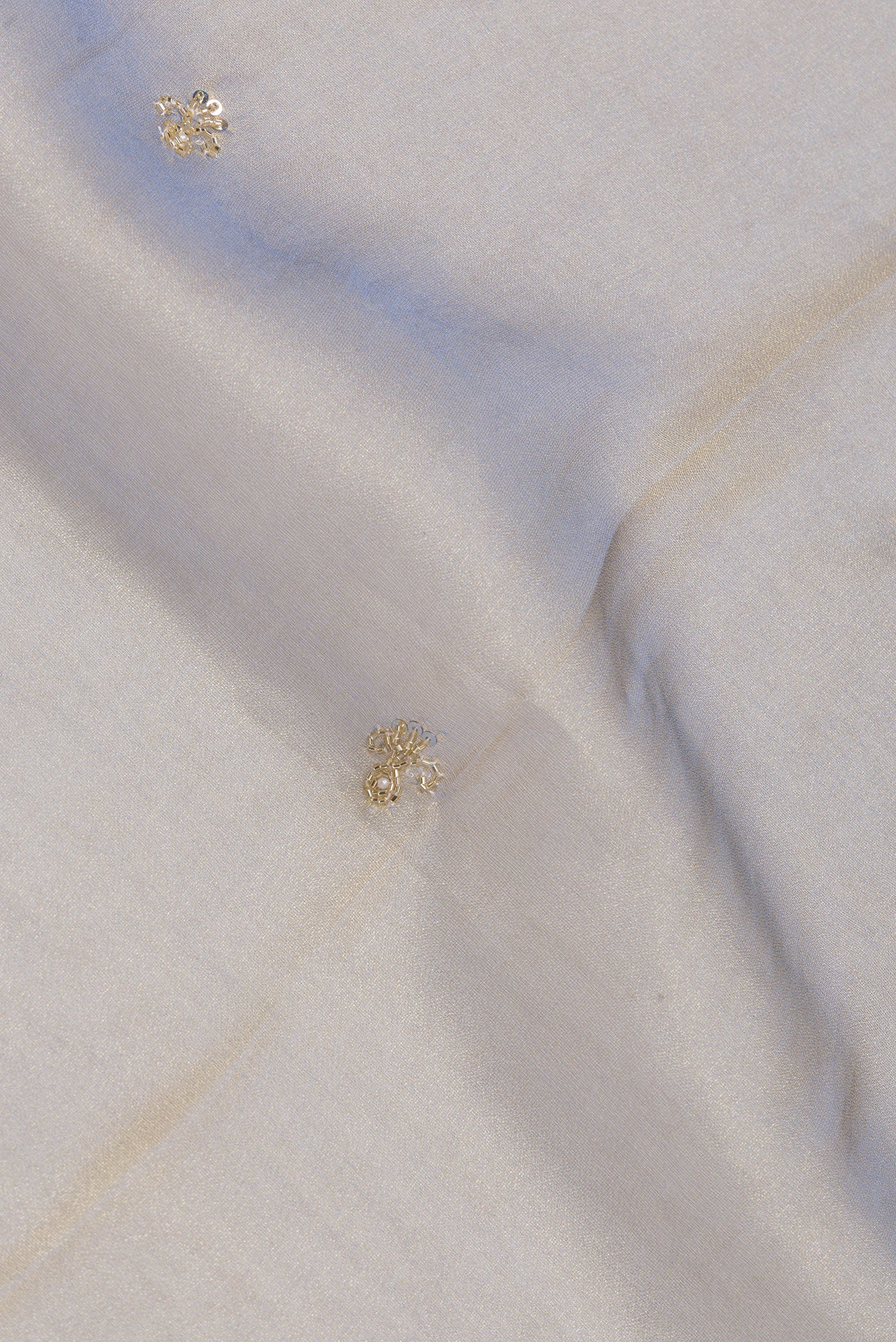 Close up of Light Blue Dual Tone Organza Silk Saree with Embroidery on the body and Sequin Border.  displaying folds