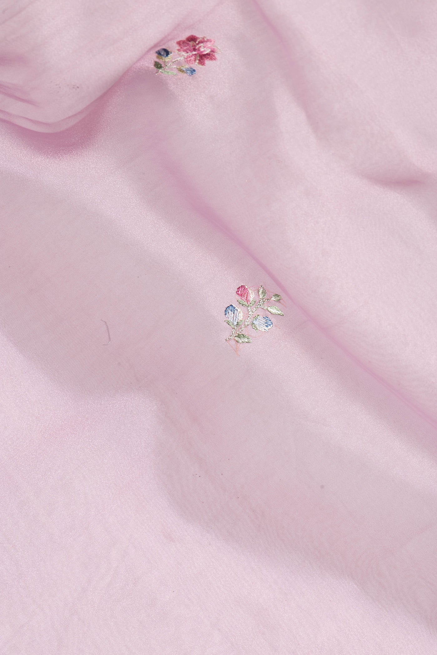 Close up of Lavender Organza Silk Saree with Embroidery on the body and Embroidery Border.  displaying folds