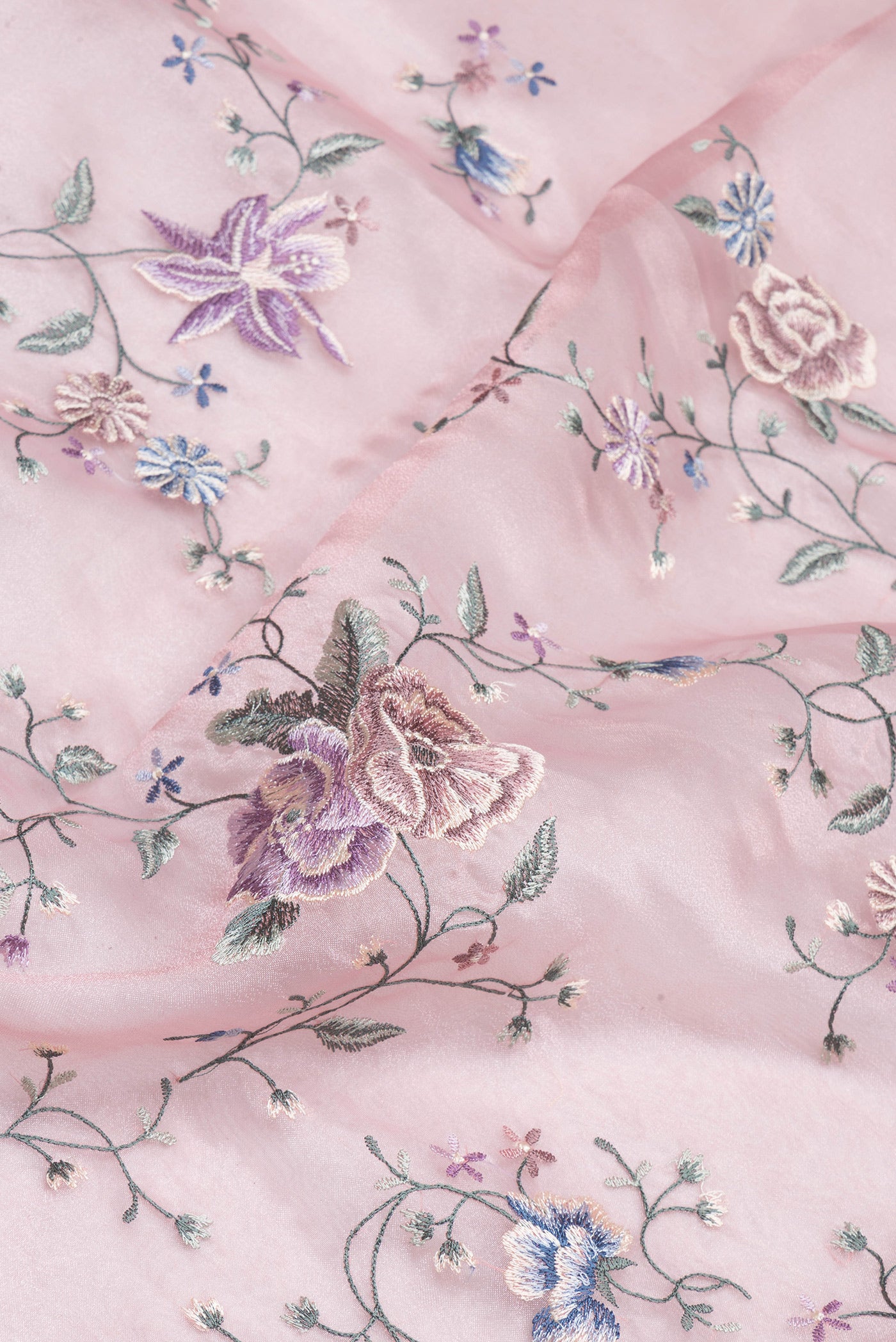 Close up of Rose pink Organza Silk Saree with Embroidery on the body and Embroidery Border.  displaying folds