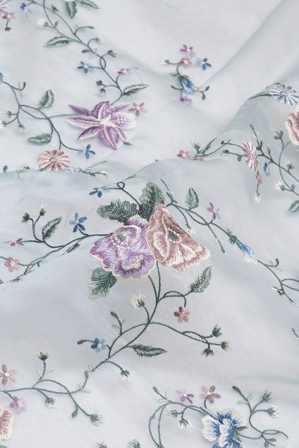 Close up of Light Blue Organza Silk Saree with Embroidery on the body and Embroidery Border.  displaying folds