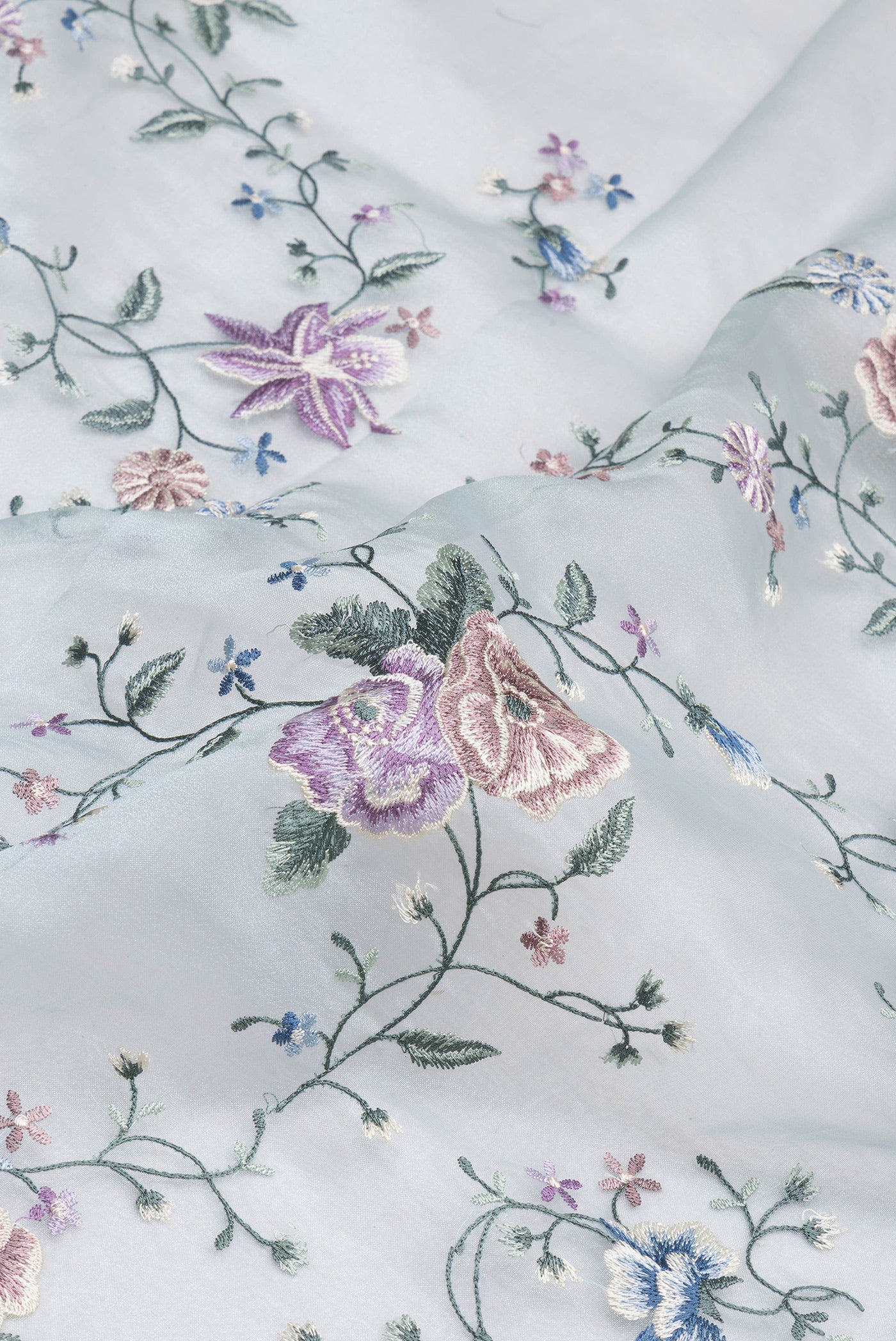 Close up of Light Blue Organza Silk Saree with Embroidery on the body and Embroidery Border.  displaying folds