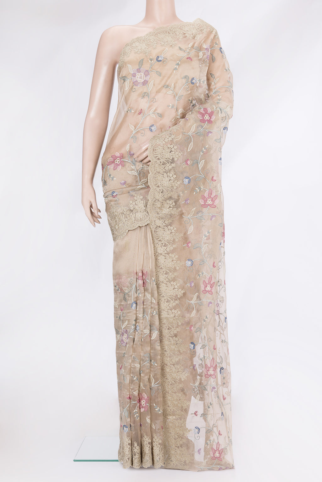 Beige Organza Silk Saree with Embroidery on the body and Embroidery Border.  displayed on a mannequin