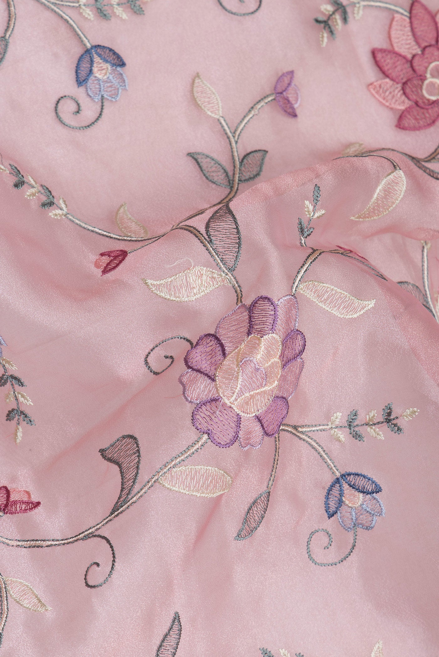 Close up of Rose pink Organza Silk Saree with Embroidery on the body and Embroidery Border.  displaying folds