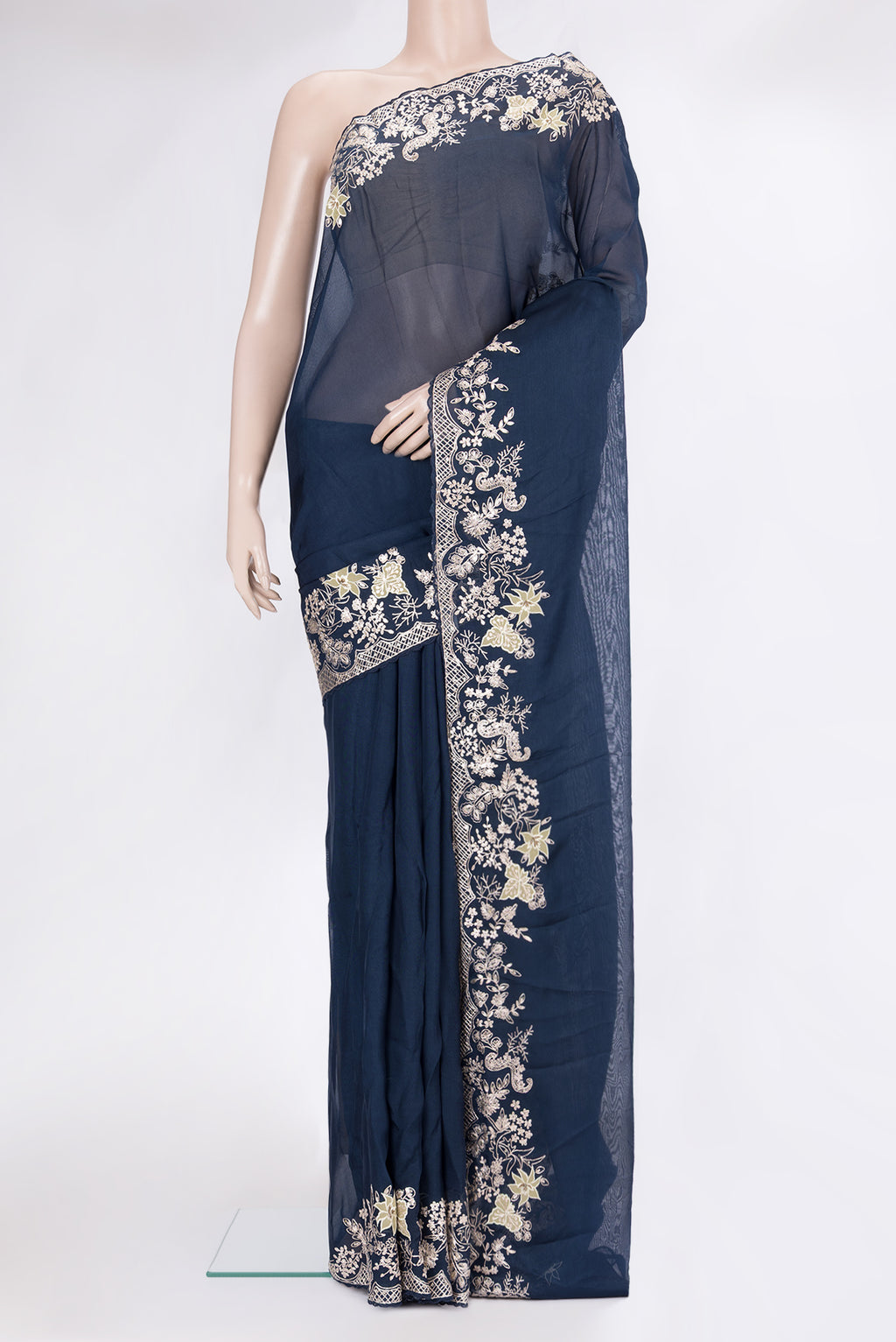 Navy Blue Organza Silk Saree with Embroidery on the body and Thread Embroidery Border.  displayed on a mannequin