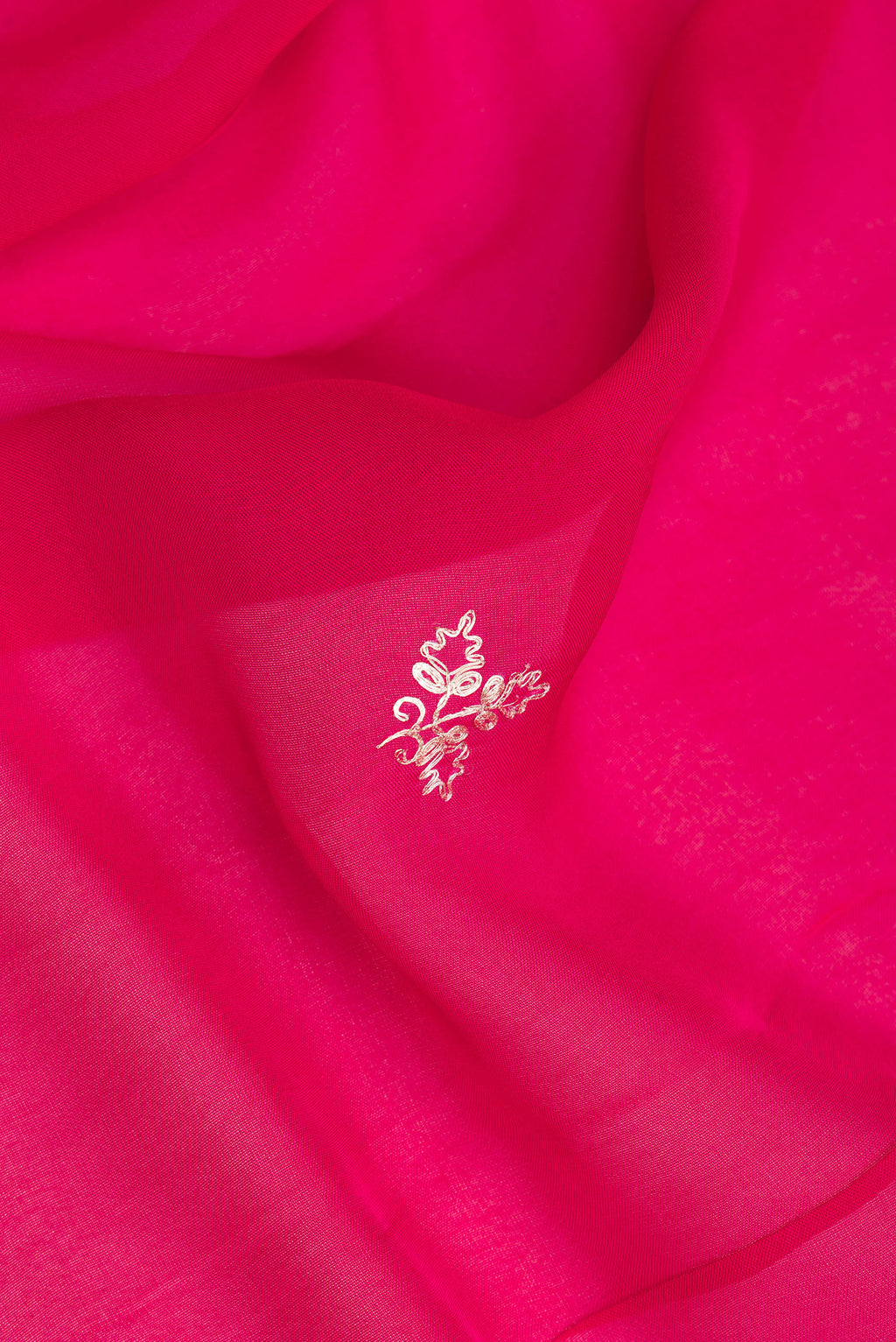 Close up of Dark Pink Organza Saree with Embroidery on the body and Embroidery Border.  displaying folds