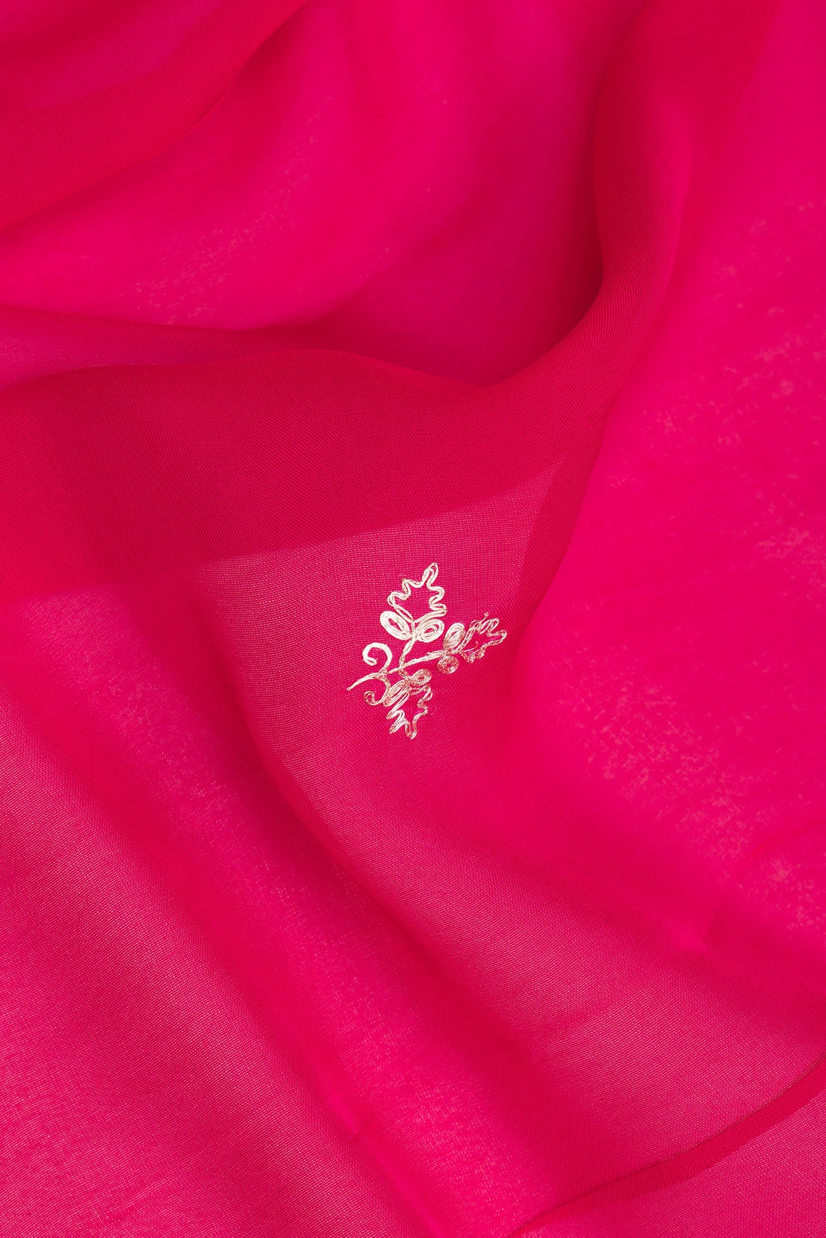 Close up of Dark Pink Organza Saree with Embroidery on the body and Embroidery Border.  displaying folds