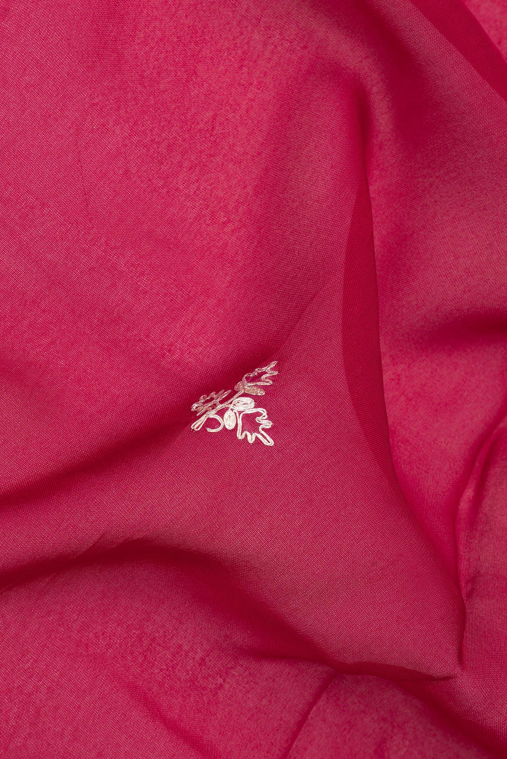 Close up of Dark Pink Banarasi Georgette Saree with Embroidery on the body and Embroidery Border.  displaying folds