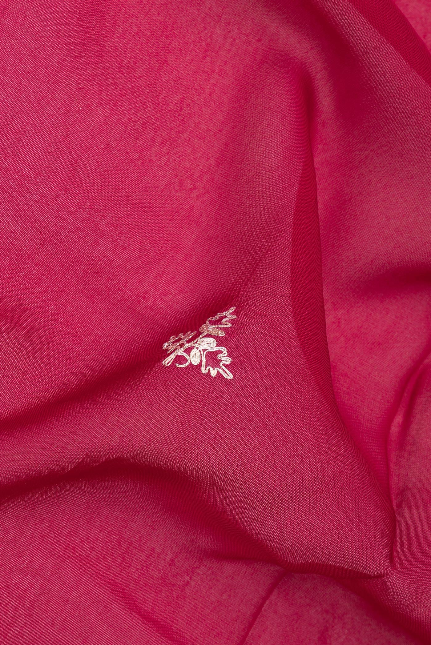 Close up of Dark Pink Banarasi Georgette Saree with Embroidery on the body and Embroidery Border.  displaying folds