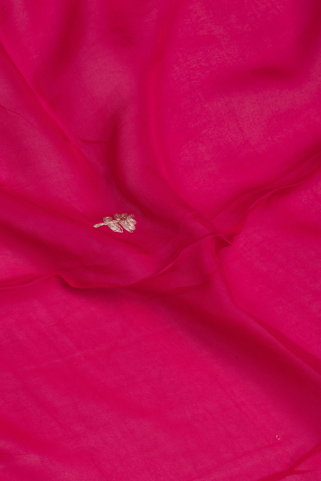 Close up of Dark Pink Organza Silk Saree with Embroidery on the body and Sequin Border.  displaying folds