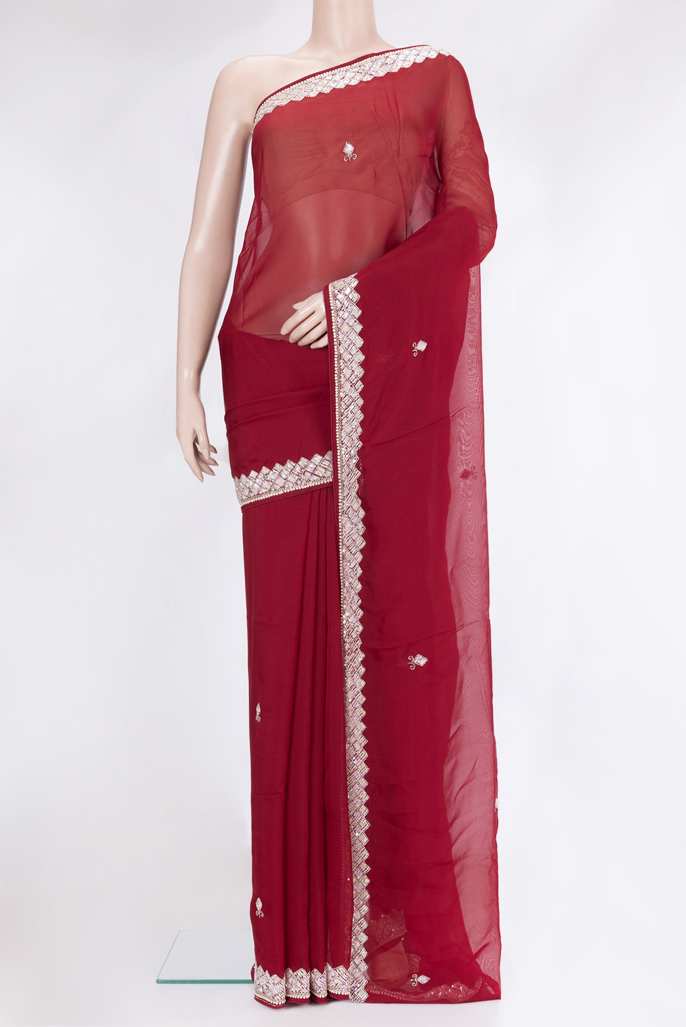 Maroon Organza Silk Saree with Embroidery on the body and Sequin Border.  displayed on a mannequin