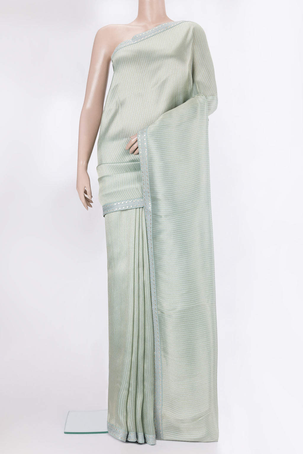 Mint Green Dual Tone Organza Saree with Embroidery on the body and Sequin Border.  displayed on a mannequin