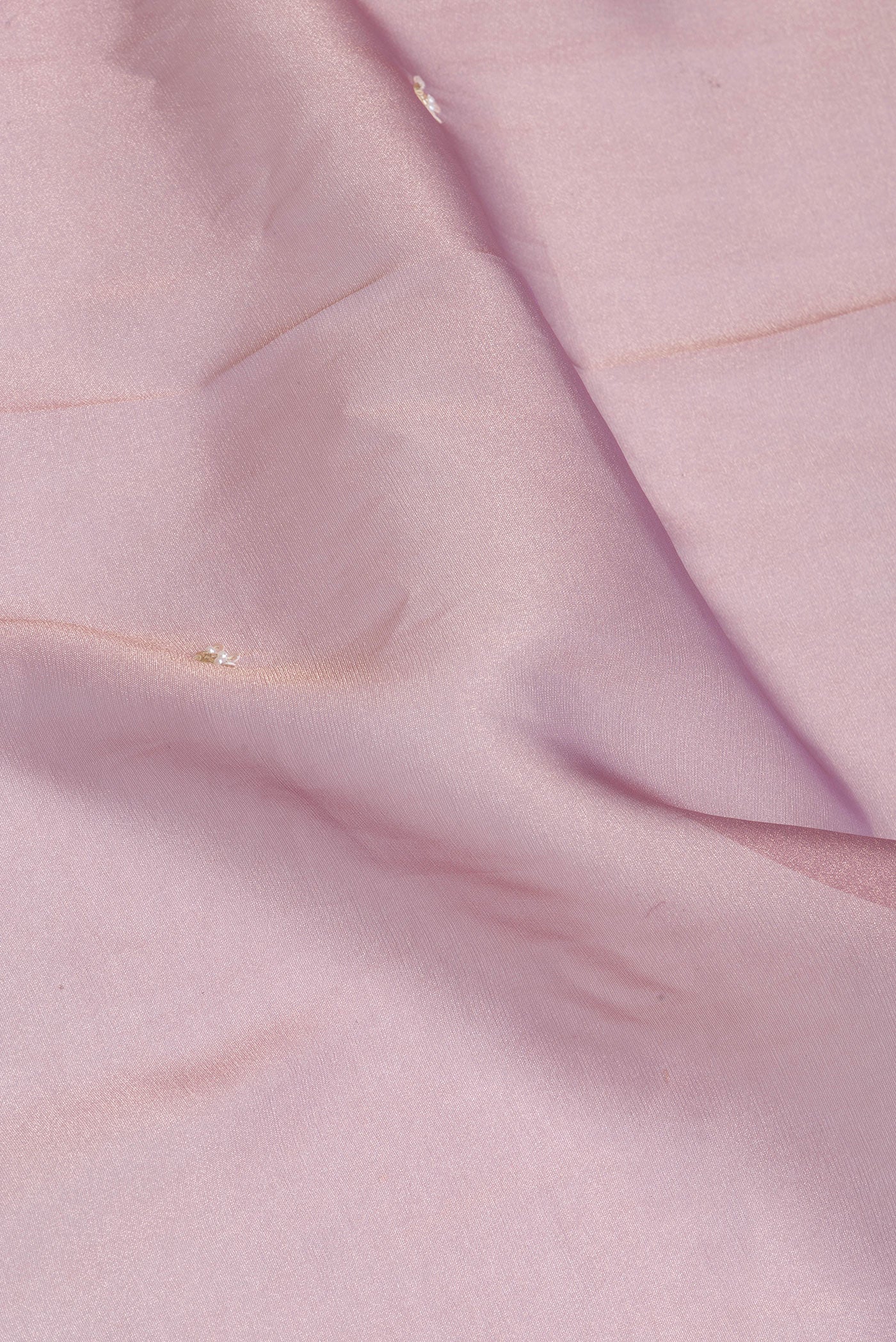 Close up of Purple Organza Silk Saree with Embroidery on the body and Sequin Border.  displaying folds