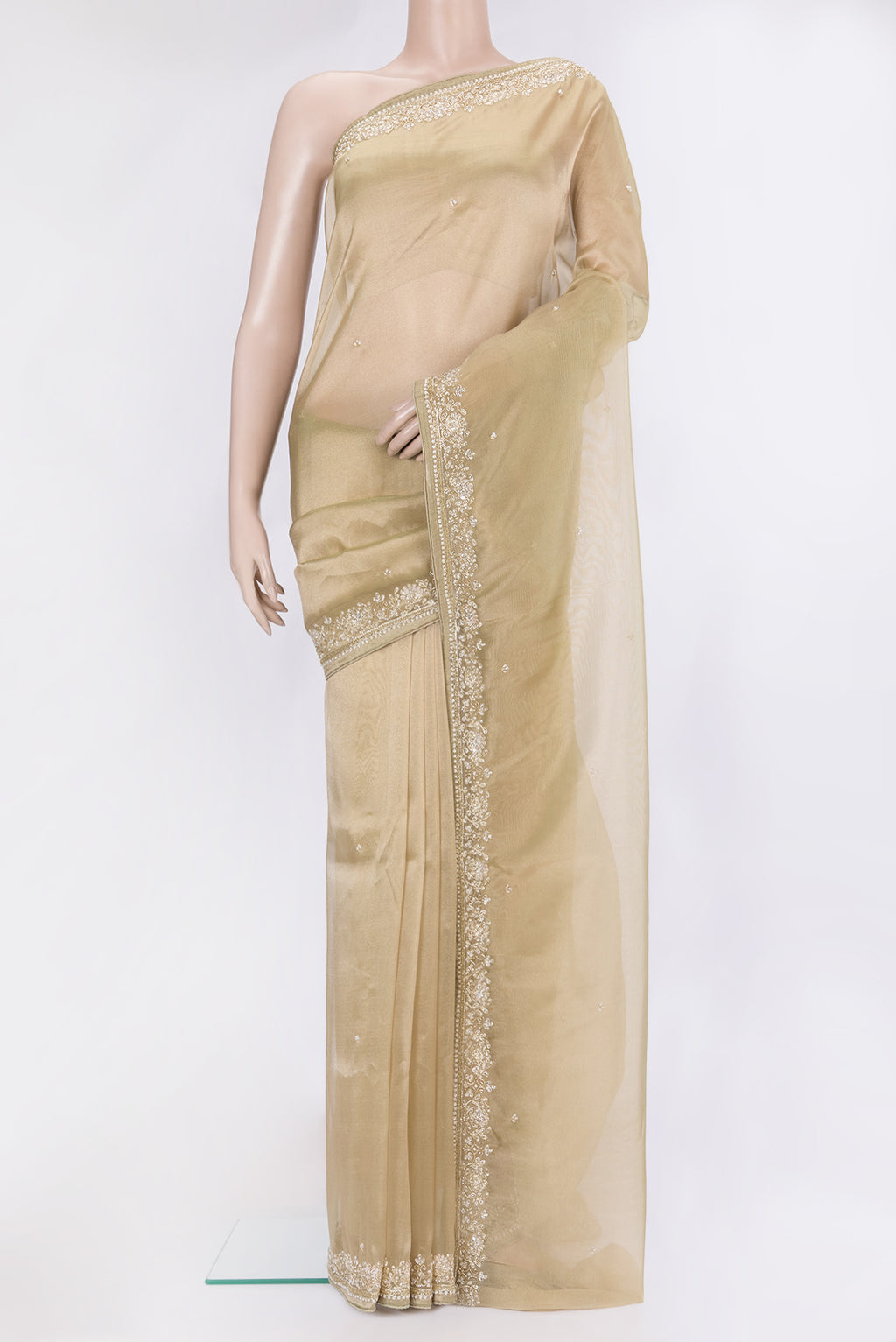 Beige Organza Silk Saree with Embroidery on the body and Sequin Border.  displayed on a mannequin