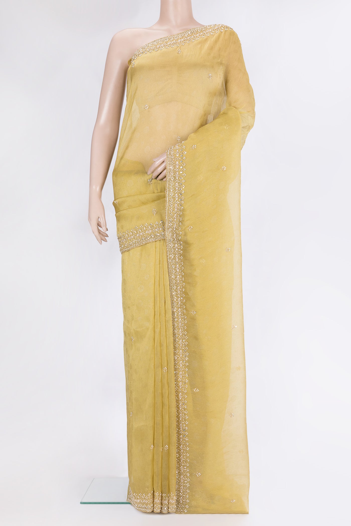 Gold Organza Silk Saree with Embroidery on the body and Sequin Border.  displayed on a mannequin