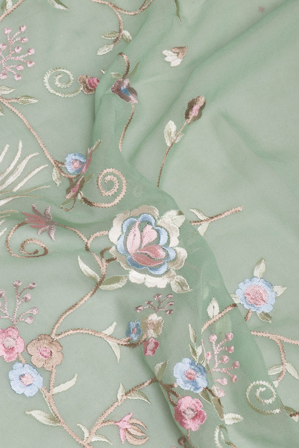 Close up of Sage Green Georgette Saree with Embroidery on the body and Embroidery Border.  displaying folds