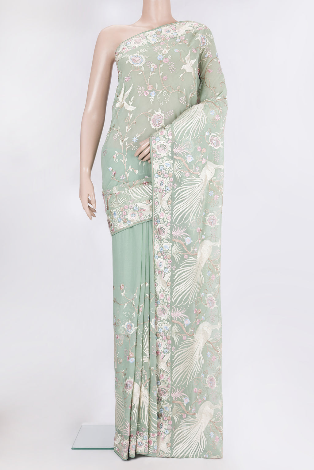Sage Green Georgette Saree with Embroidery on the body and Embroidery Border.  displayed on a mannequin