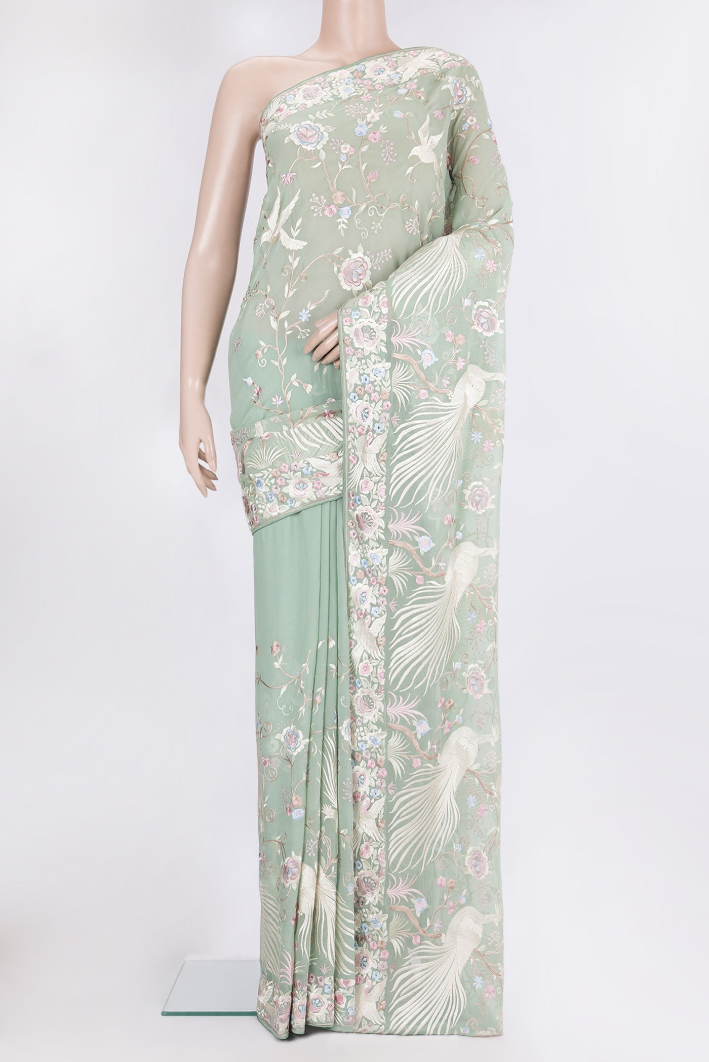 Sage Green Georgette Saree with Embroidery on the body and Embroidery Border.  displayed on a mannequin