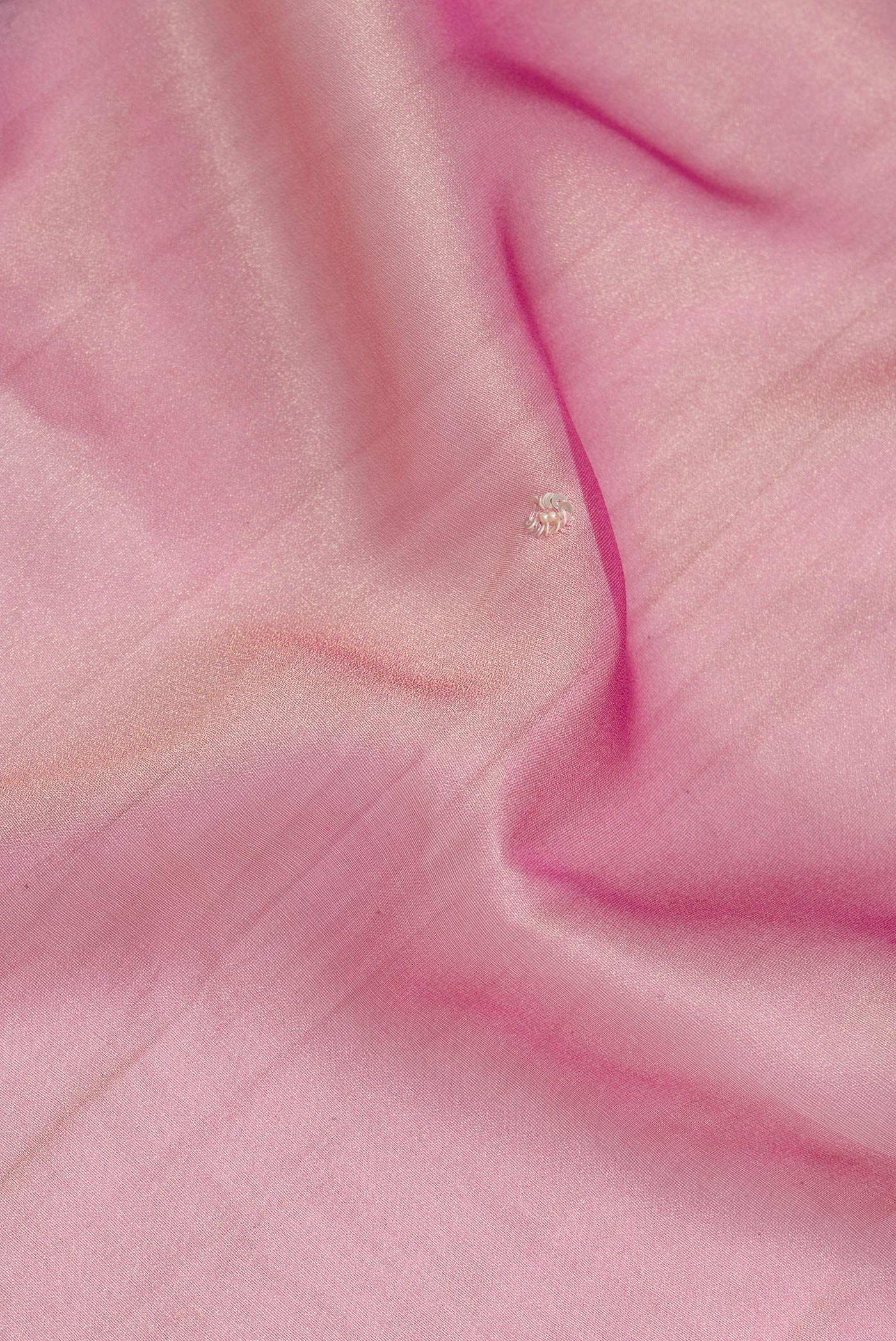 Close up of Pink Dual Tone Organza Silk Saree with Embroidery on the body and Embroidery Border.  displaying folds