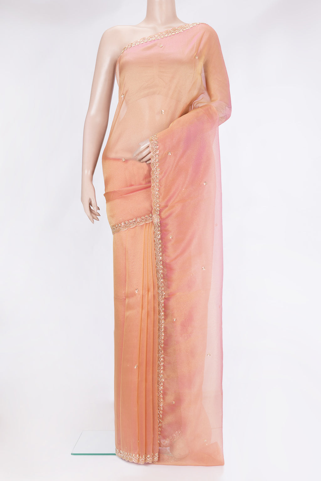 Golden Peach Organza Silk Saree with Embroidery on the body and Sequin Border.  displayed on a mannequin