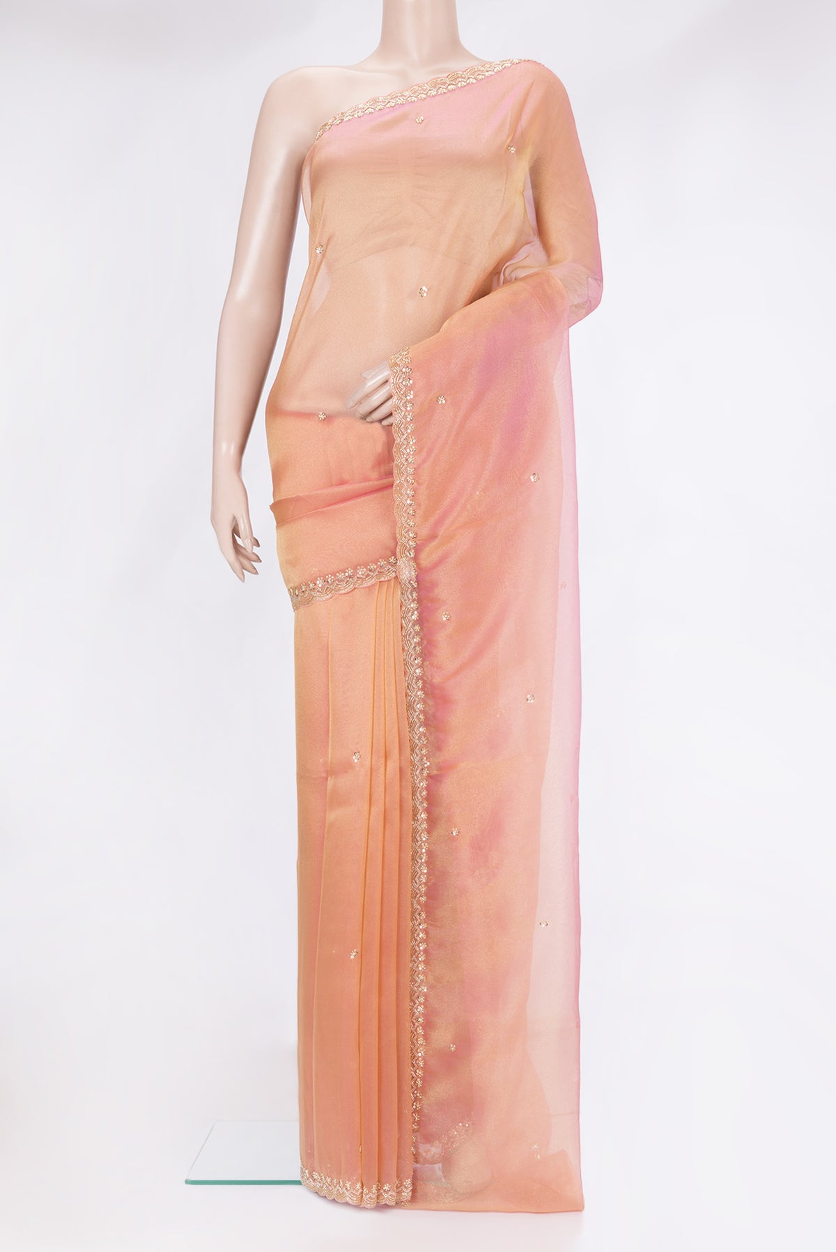 Golden Peach Organza Silk Saree with Embroidery on the body and Sequin Border.  displayed on a mannequin