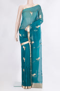 Peacock Blue Organza Saree with Zari Butta on the body and Zari Border.  displayed on a mannequin