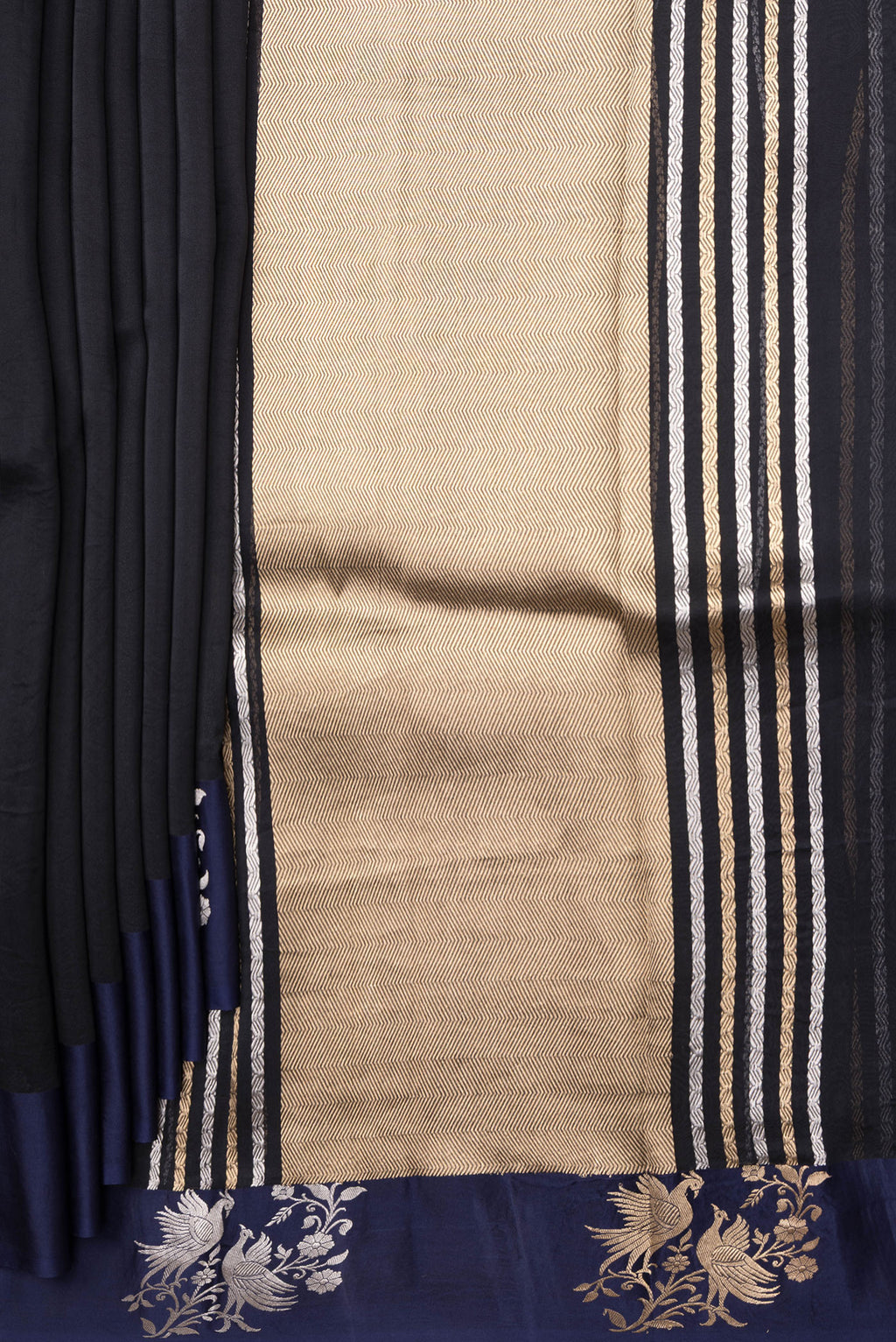 Pleats and pallu of Navy Blue Organza Silk Saree with Zari Butta on the body and Fancy Border. 