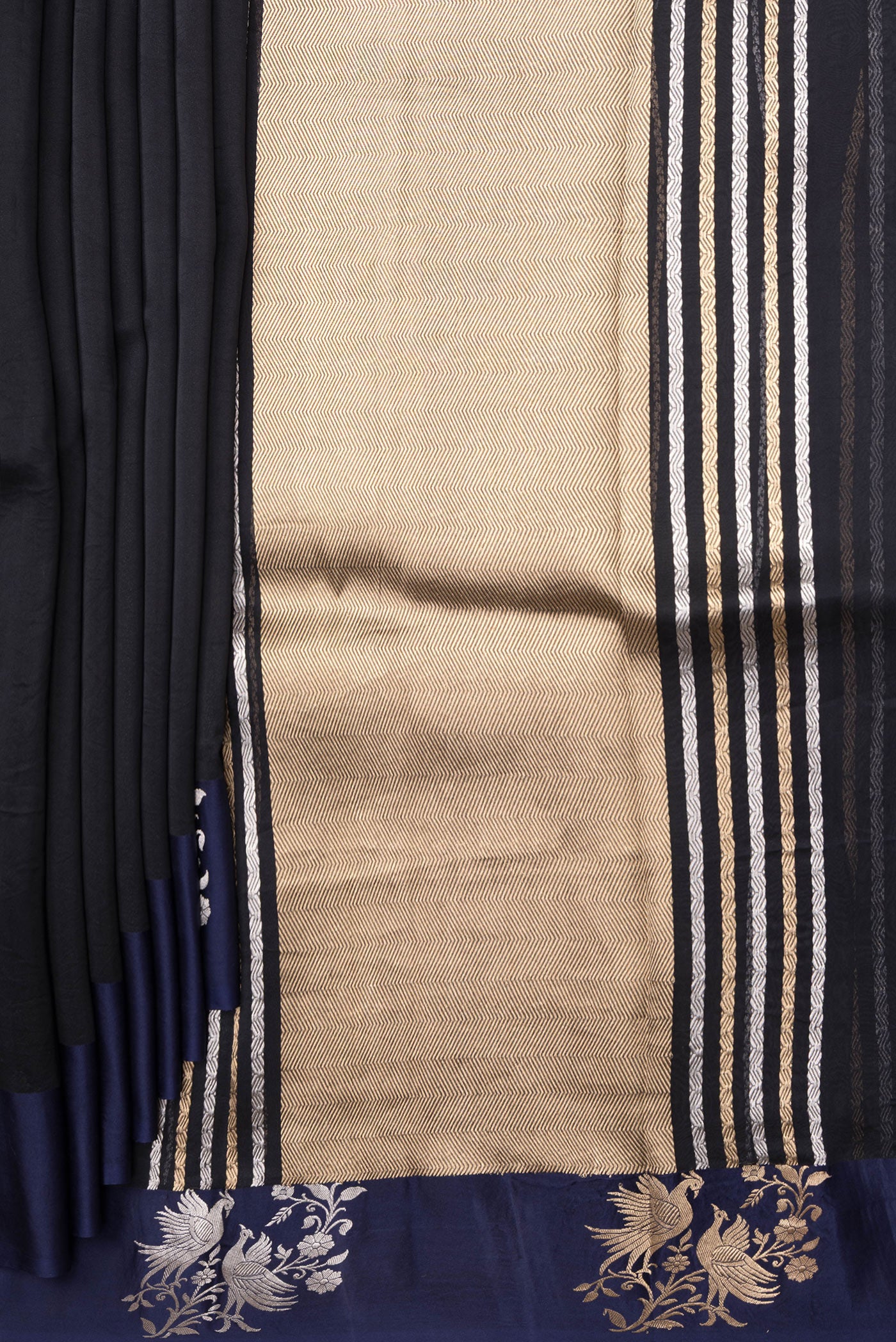Pleats and pallu of Navy Blue Organza Silk Saree with Zari Butta on the body and Fancy Border. 