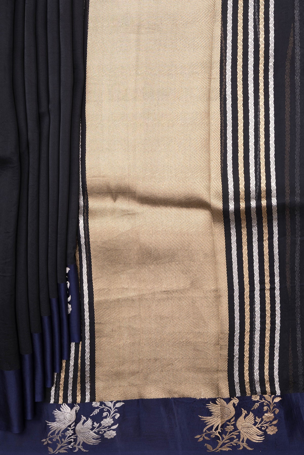 Pleats and pallu of Navy Blue Organza Silk Saree with Zari Butta on the body and Fancy Border. 