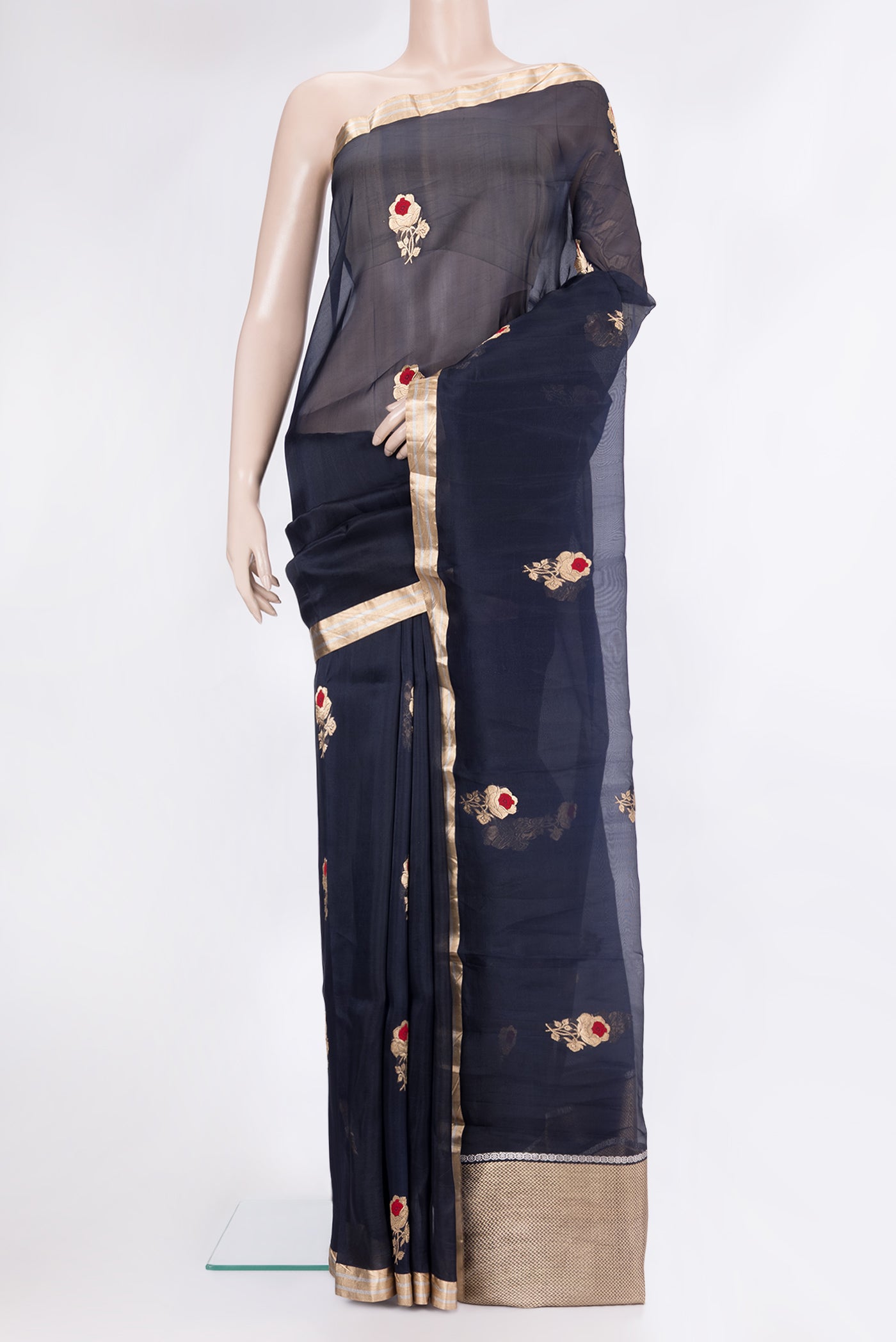 Navy Blue Organza Silk Saree with Zari And Thread Butta on the body and Zari Border.  displayed on a mannequin
