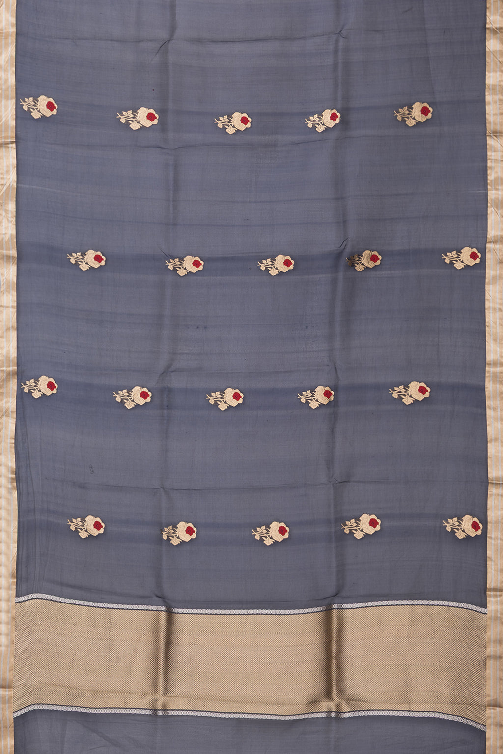 Flat view of Navy Blue Organza Silk Saree with Zari And Thread Butta on the body and Zari Border. 