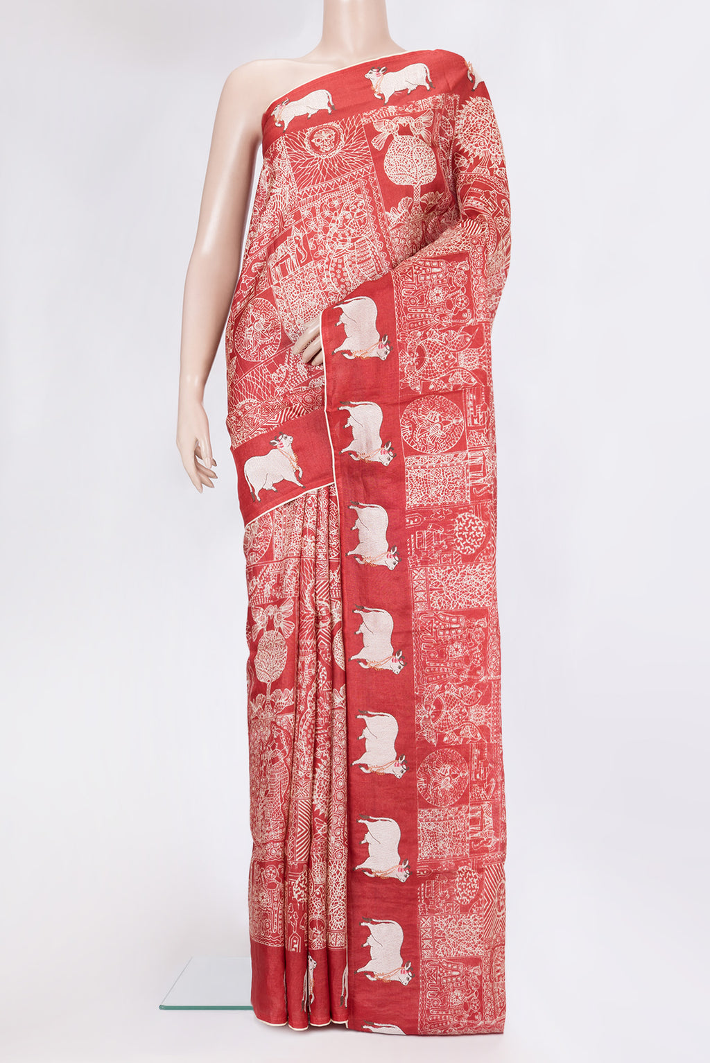 Red Tussar Silk Saree with Printed design on the body and Fancy Border.  displayed on a mannequin