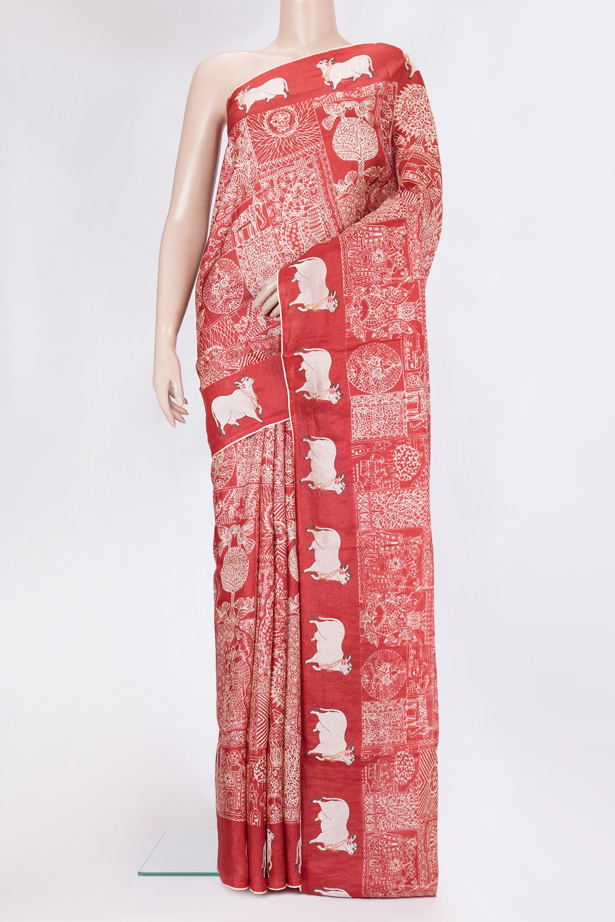 Red Tussar Silk Saree with Printed design on the body and Fancy Border.  displayed on a mannequin