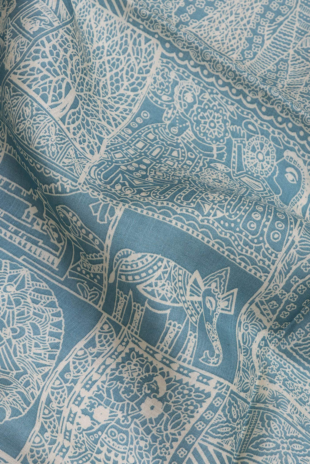 Close up of Light Blue Tussar Silk Saree with Printed design on the body and Embroidery Border.  displaying folds