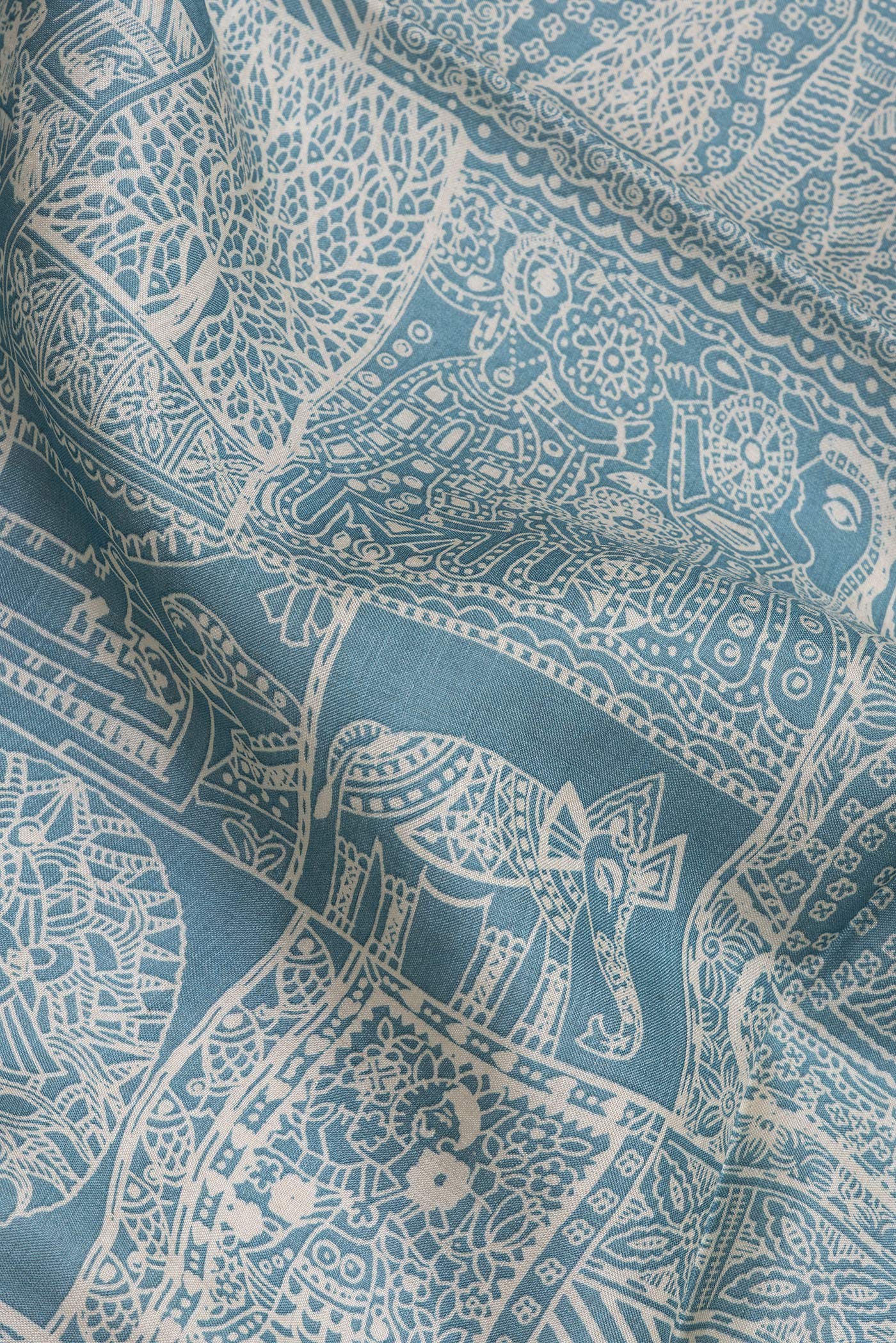 Close up of Light Blue Tussar Silk Saree with Printed design on the body and Embroidery Border.  displaying folds
