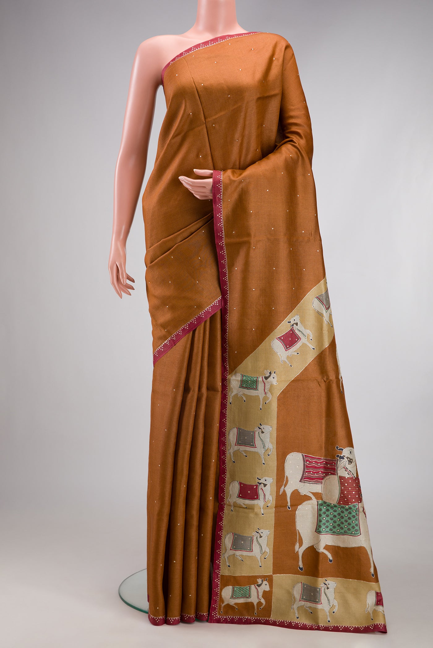 Brick Orange Dual Tone Tussar Silk Saree with Embroidery on the body and Embroidery Border.  displayed on a mannequin