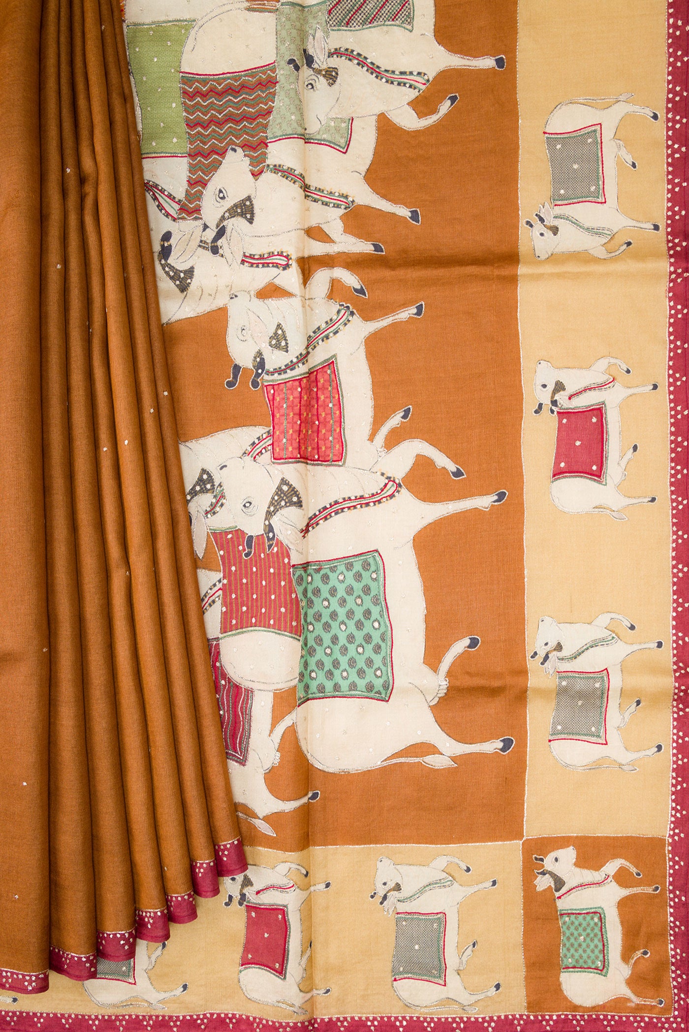 Pleats and pallu of Brick Orange Dual Tone Tussar Silk Saree with Embroidery on the body and Embroidery Border. 